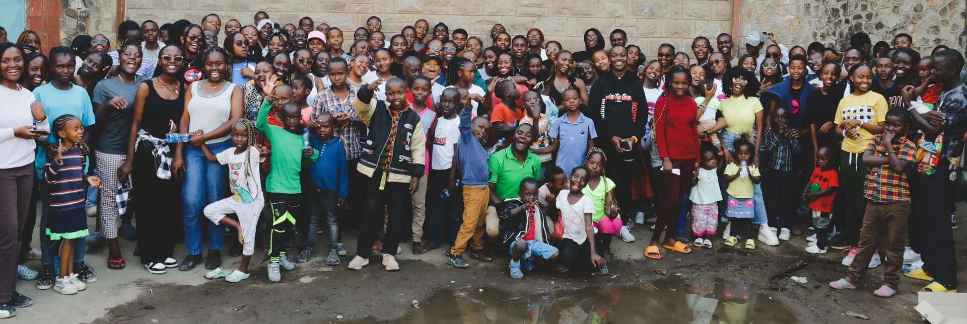 A large group of Furaha members and community members posing together